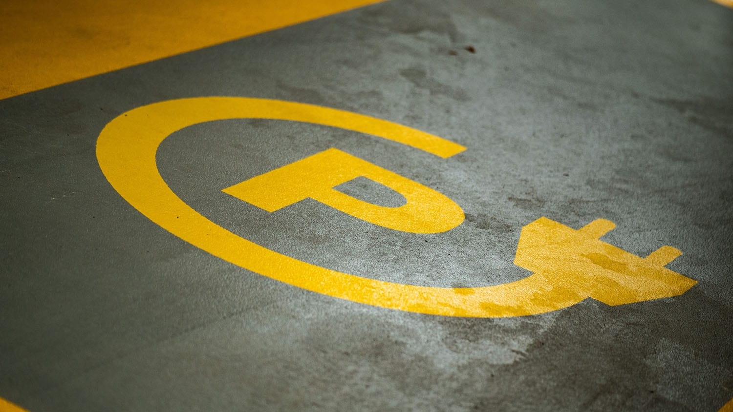 Parking space features sign specifying it is for charging electric vehicles only